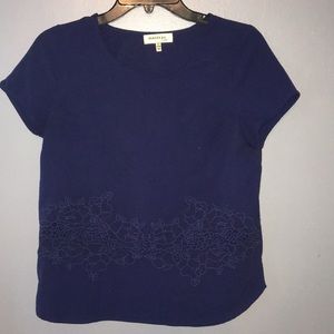 Blue shirt with cut out flowers